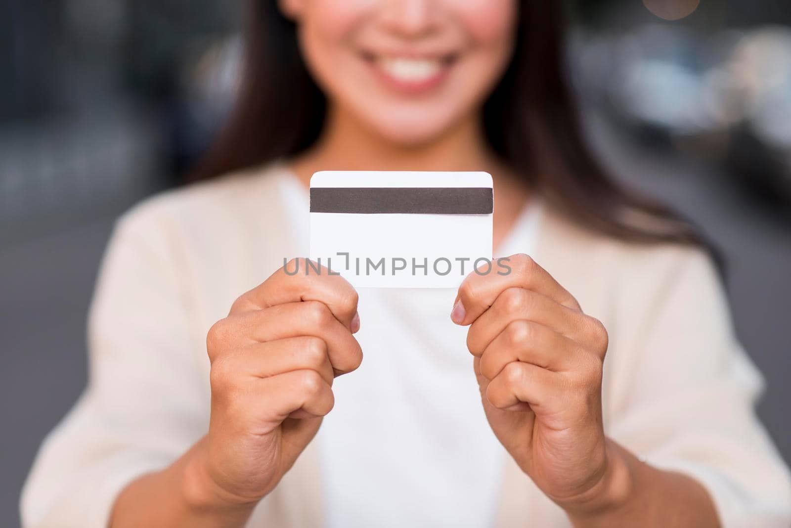 smiley defocused woman holding credit card by Zahard