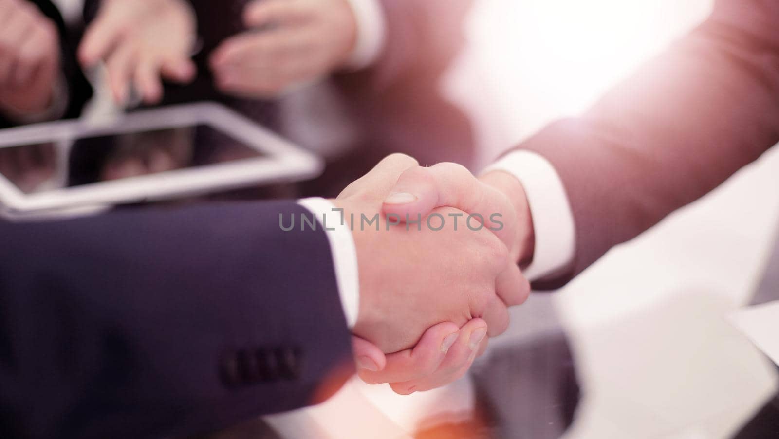 Two confident business man shaking hands by asdf