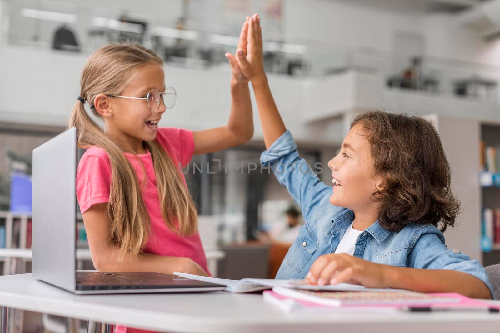 kids high fiving library