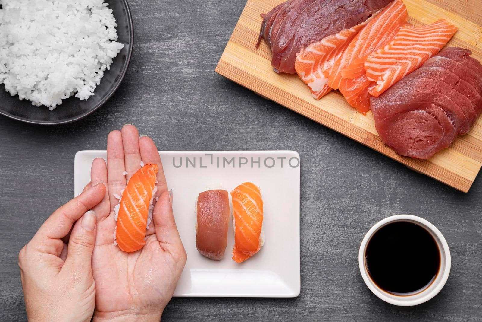 close up hands preparing sushi