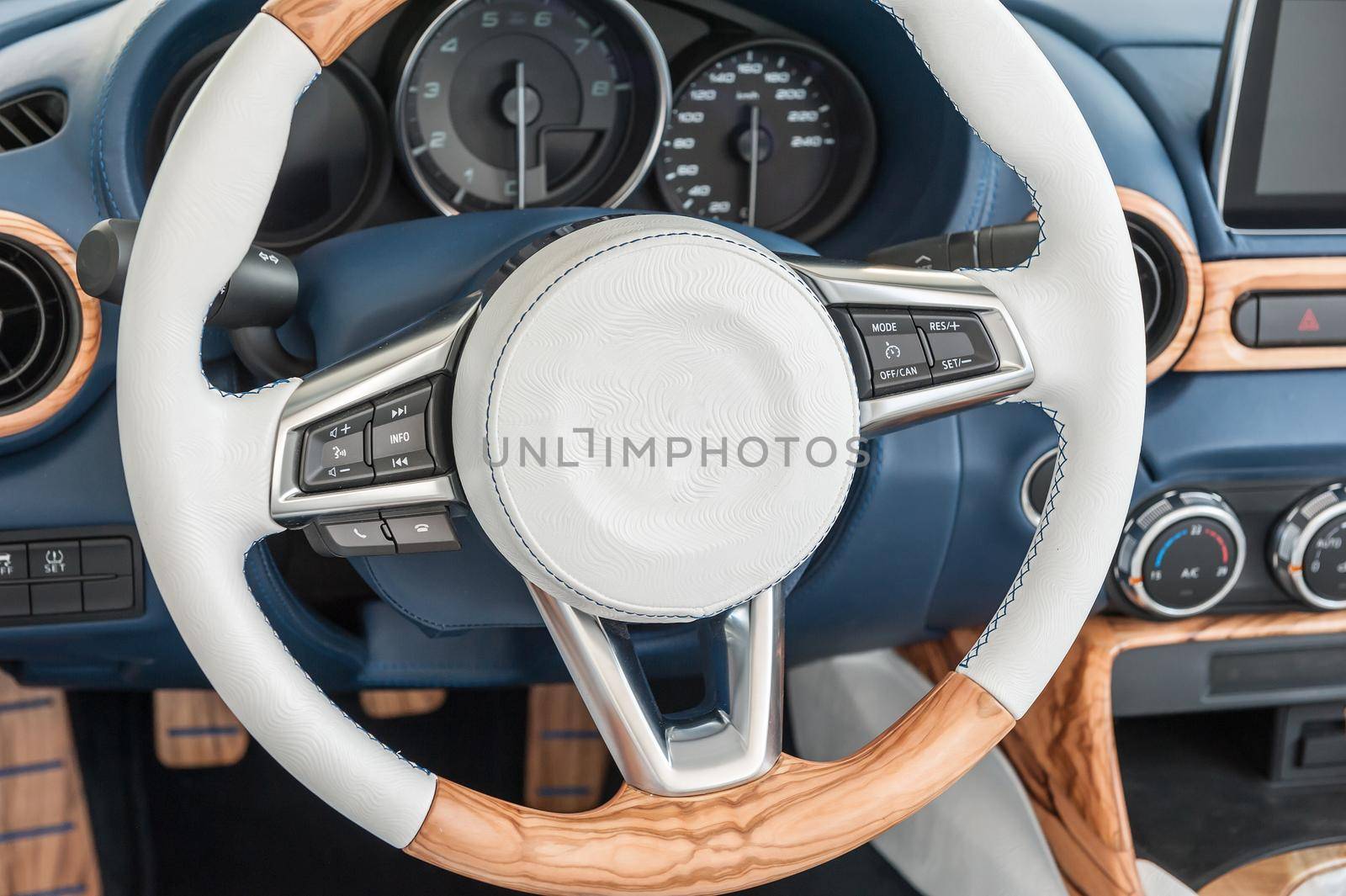 Modern car interior with a white wheel
