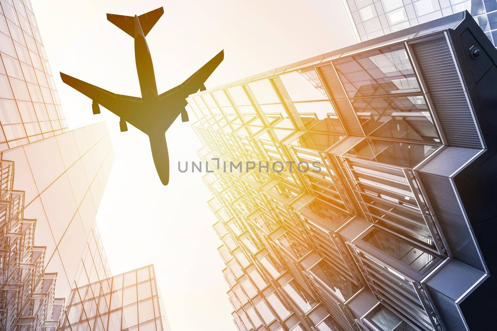 Airplane flying over moder skyscrapers in the sunset: 3D illustration