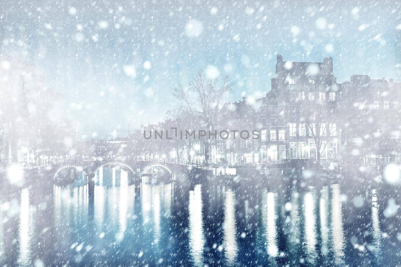 View of Amsterdam by night with snow, Netherlands