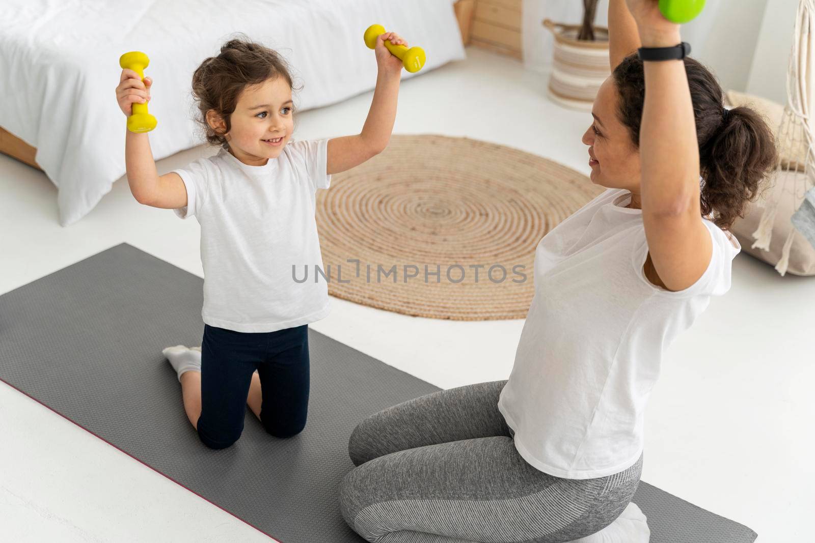 woman kid training with dumbbells