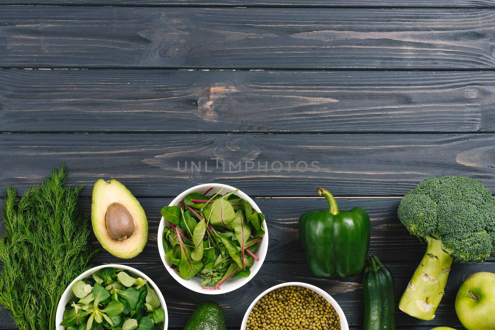 green fresh vegetables black wooden desk