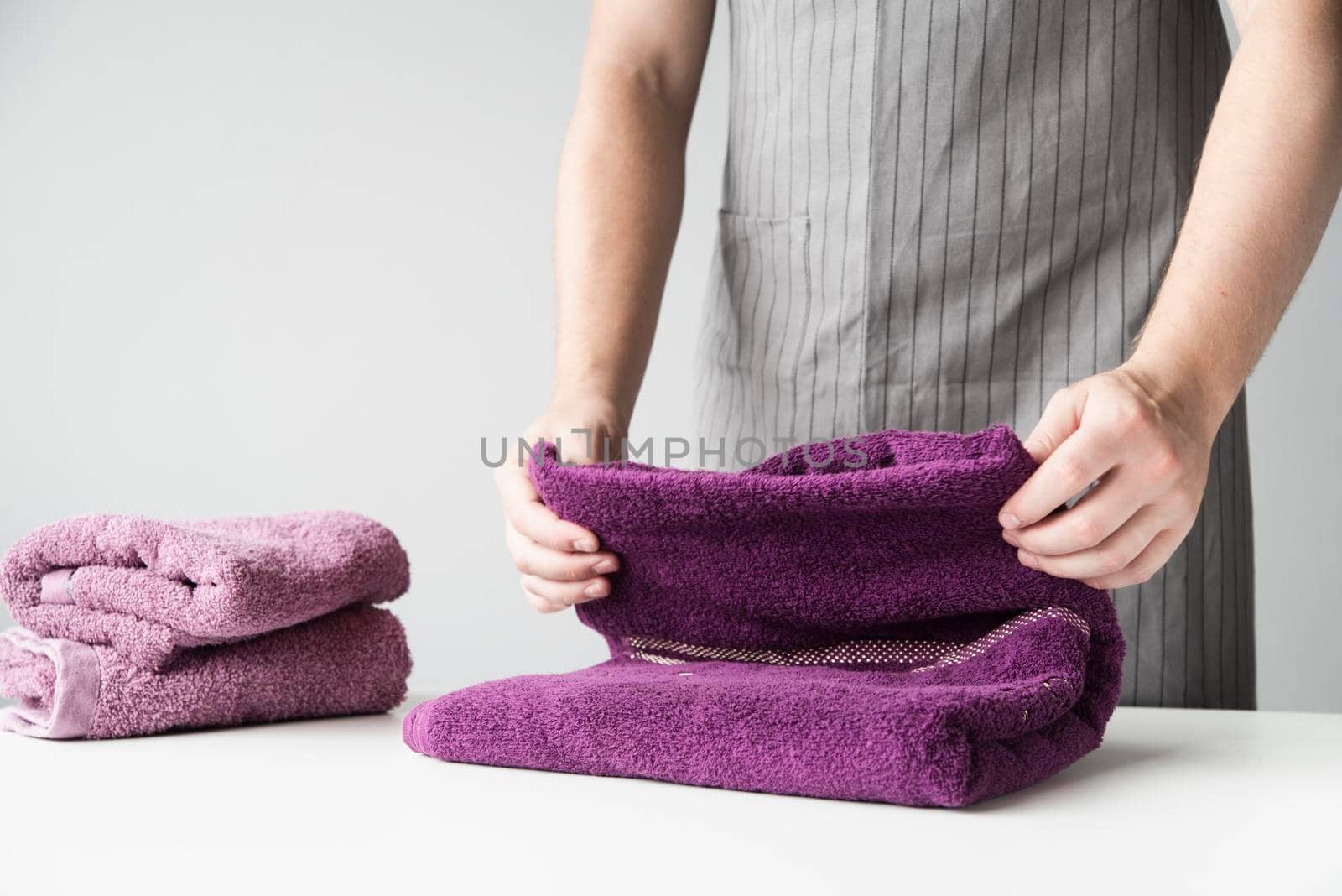 front view person folding towels by Zahard
