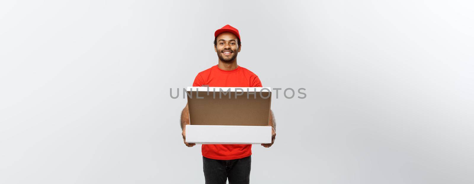 Delivery Concept - Portrait of Handsome African American Pizza delivery man. Isolated on Grey studio Background. Copy Space