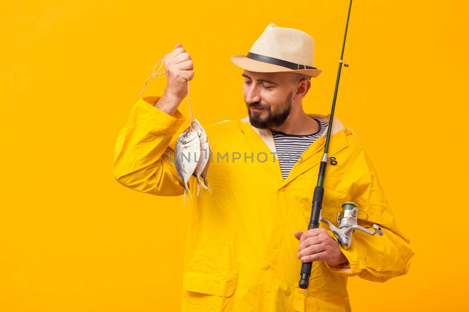 front view proud fisherman holding catch fishing rod by Zahard
