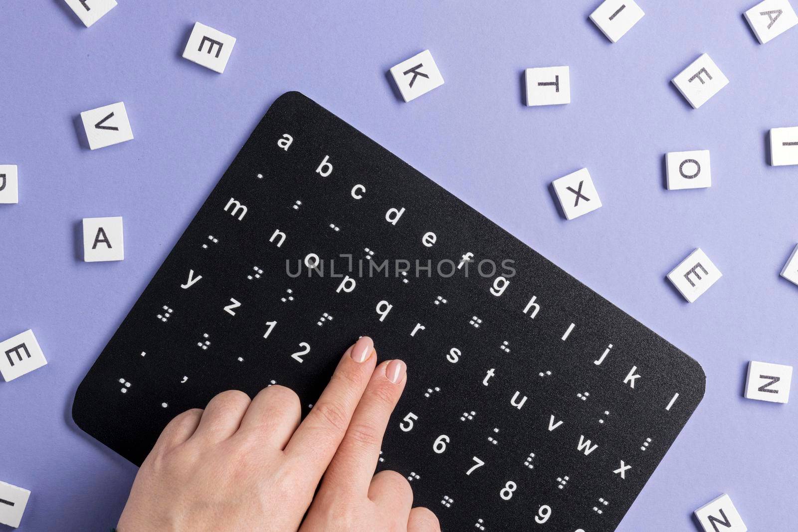 fingers touching braille alphabet board by Zahard