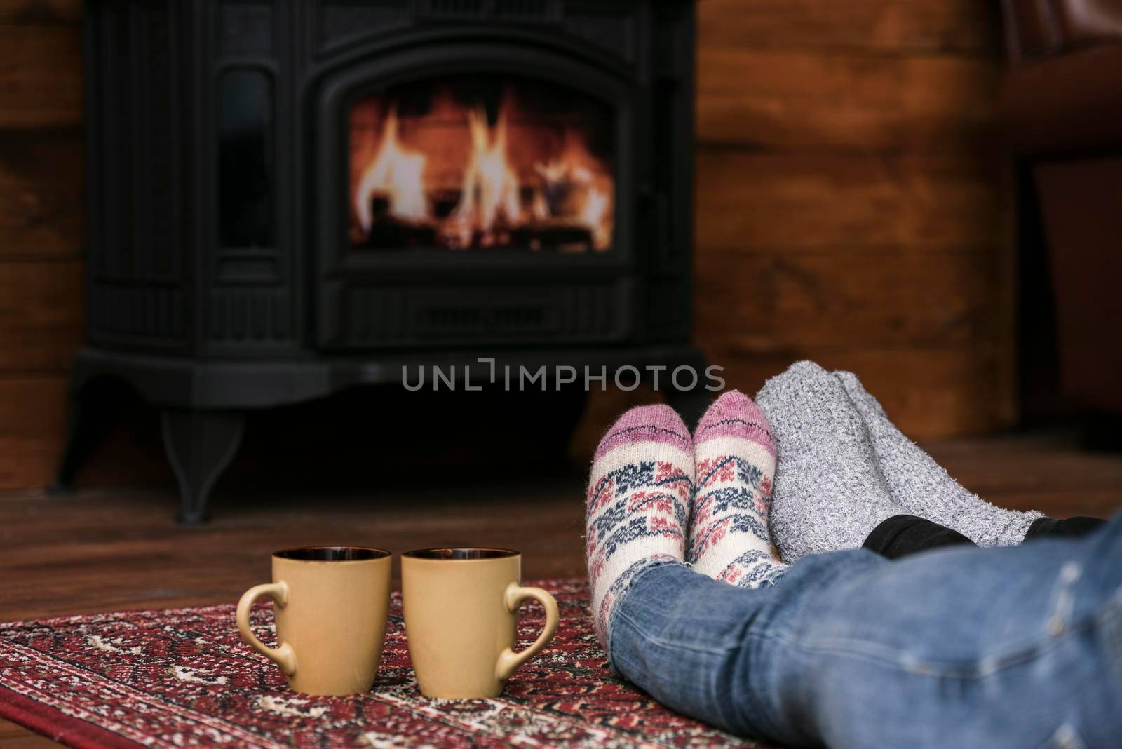 couples warming feet fireplace by Zahard