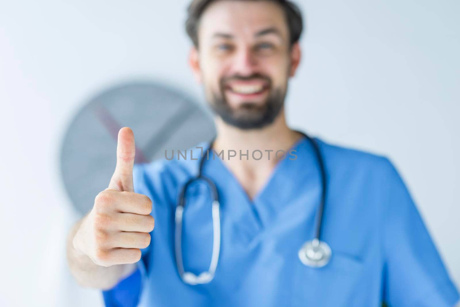 blurred doctor showing thumb up gesture by Zahard