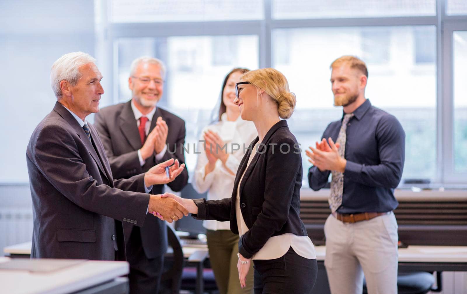 business people shaking hands after successful negotiations office by Zahard