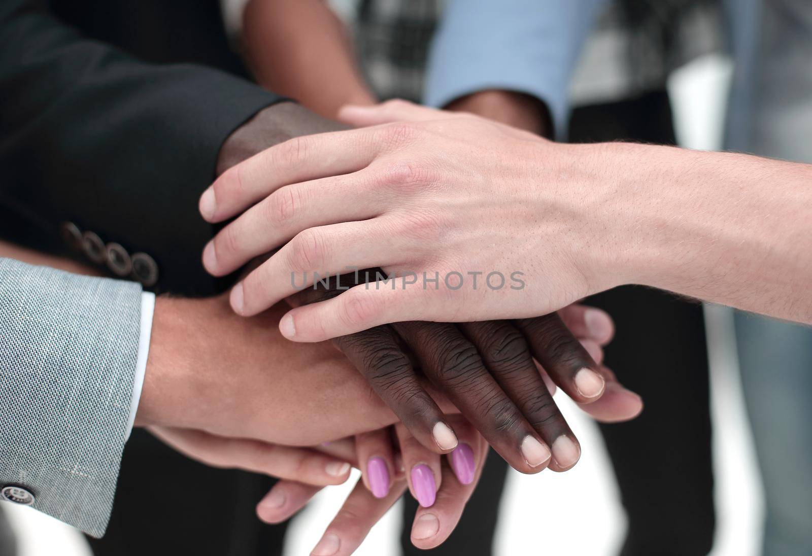 Cropped shot of a group of businesspeople piling their hands on top of each other