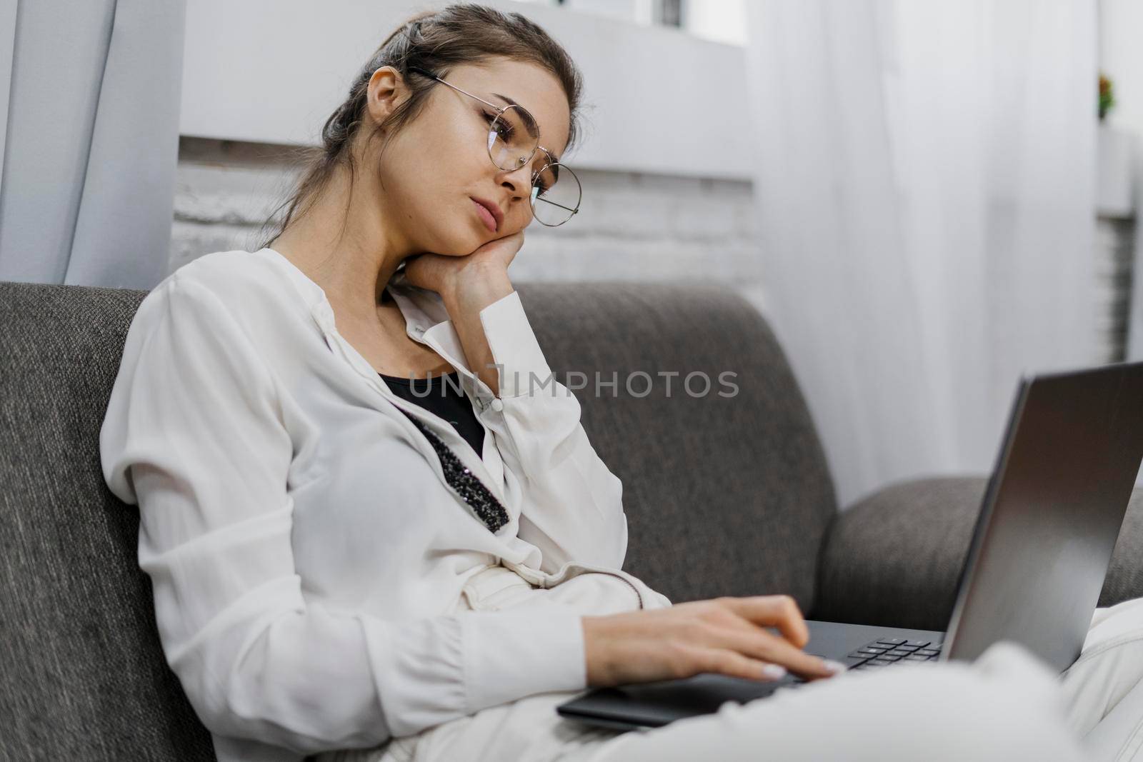 woman looking bored while working by Zahard