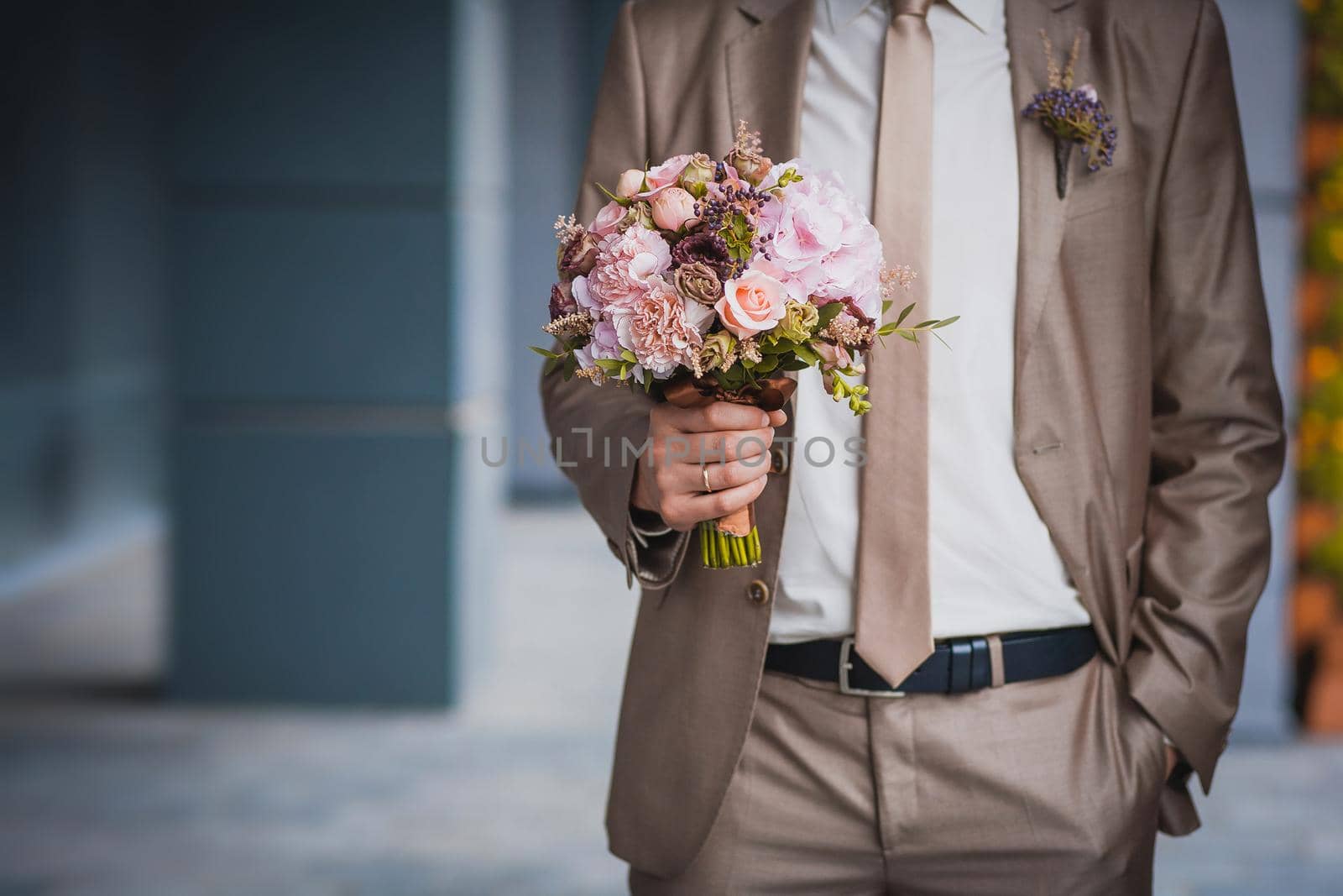 newlywed's hands on the wedding bouquet