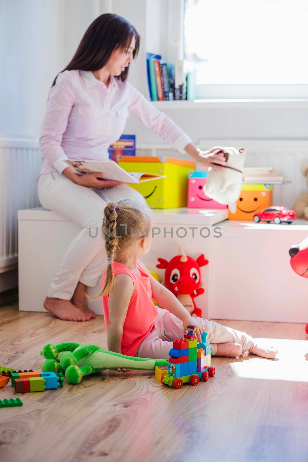 woman playing with child playroom