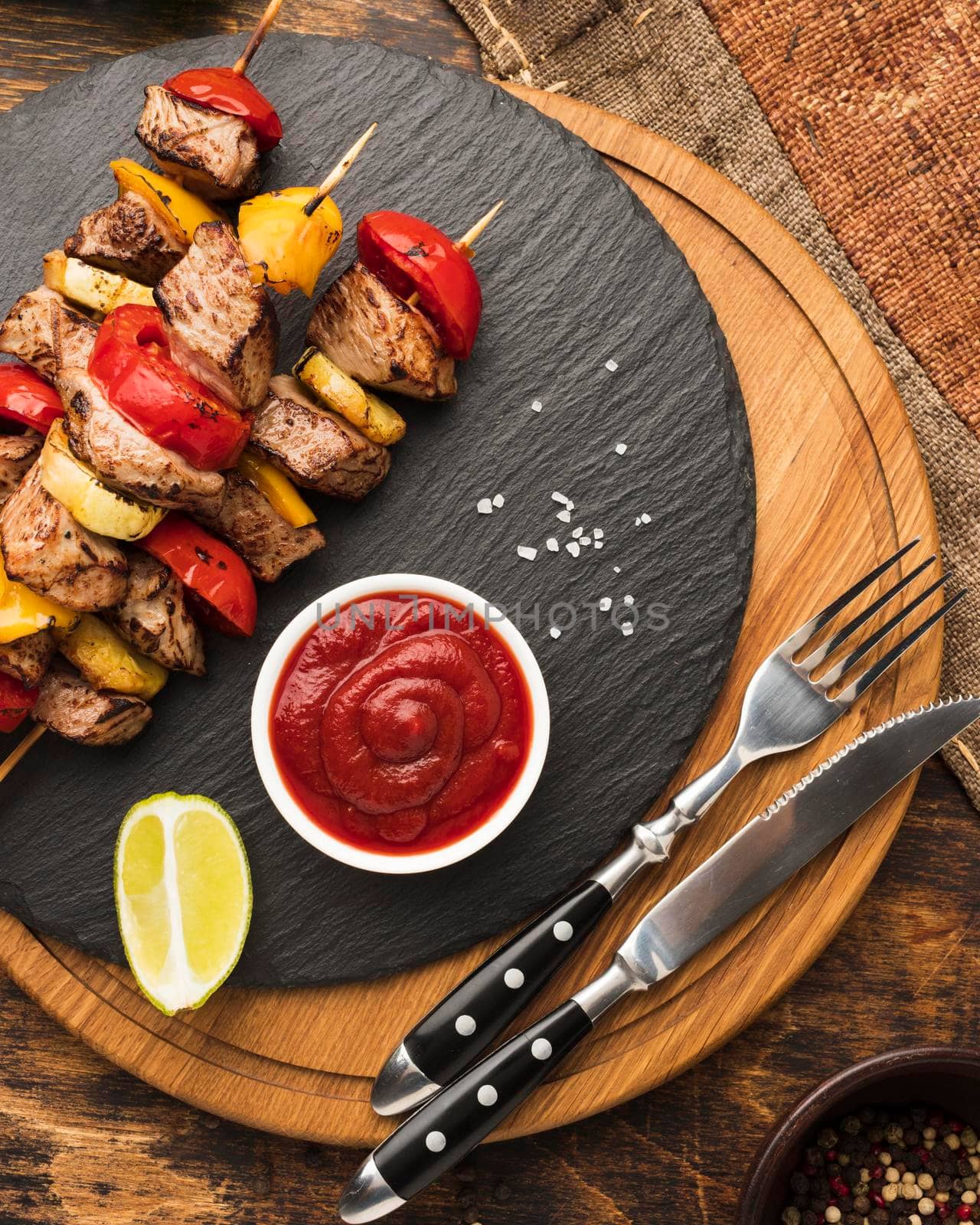 top view delicious kebab slate with ketchup cutlery by Zahard