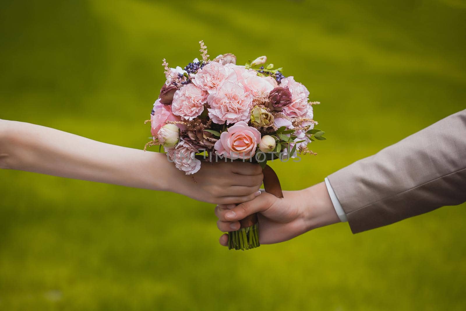 wedding bouquet in the newlywed's hands by lndstudio