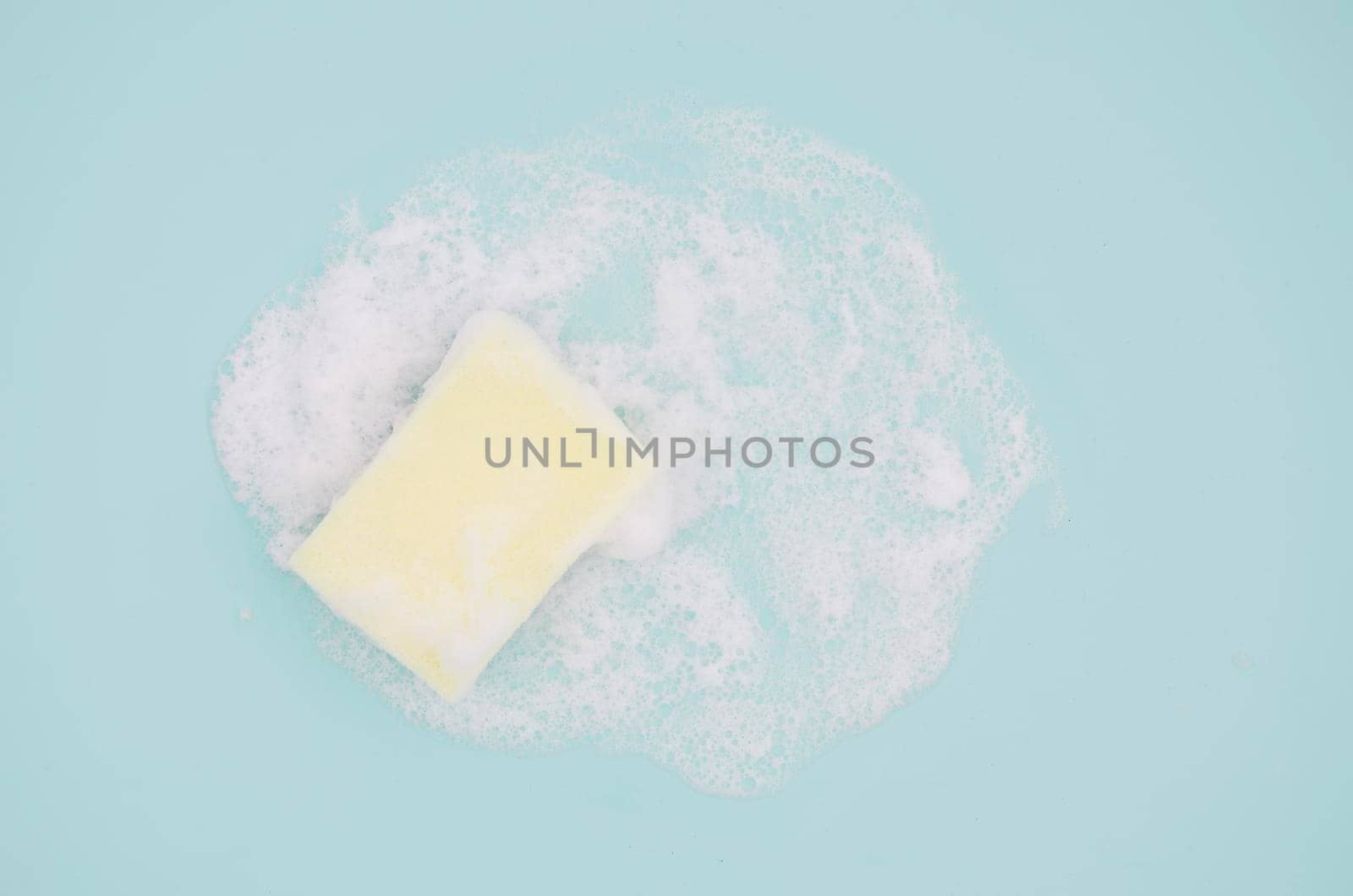 overhead view sponge with sud blue background by Zahard