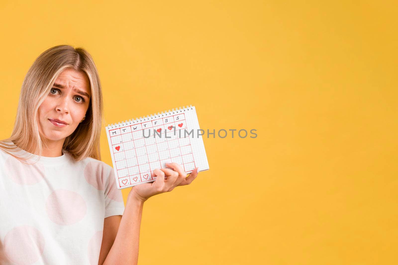 woman being upset holding period calendar
