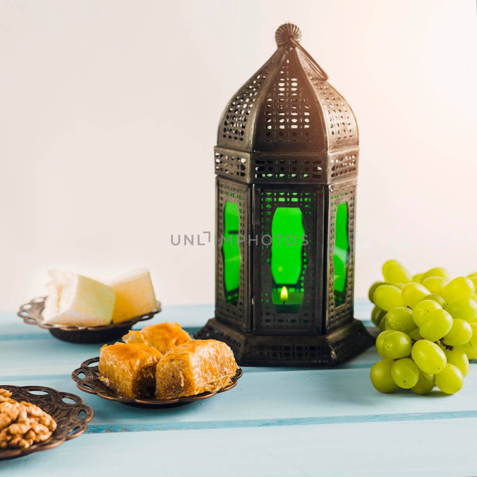 lantern near green grape with baklava turkish delights saucers by Zahard