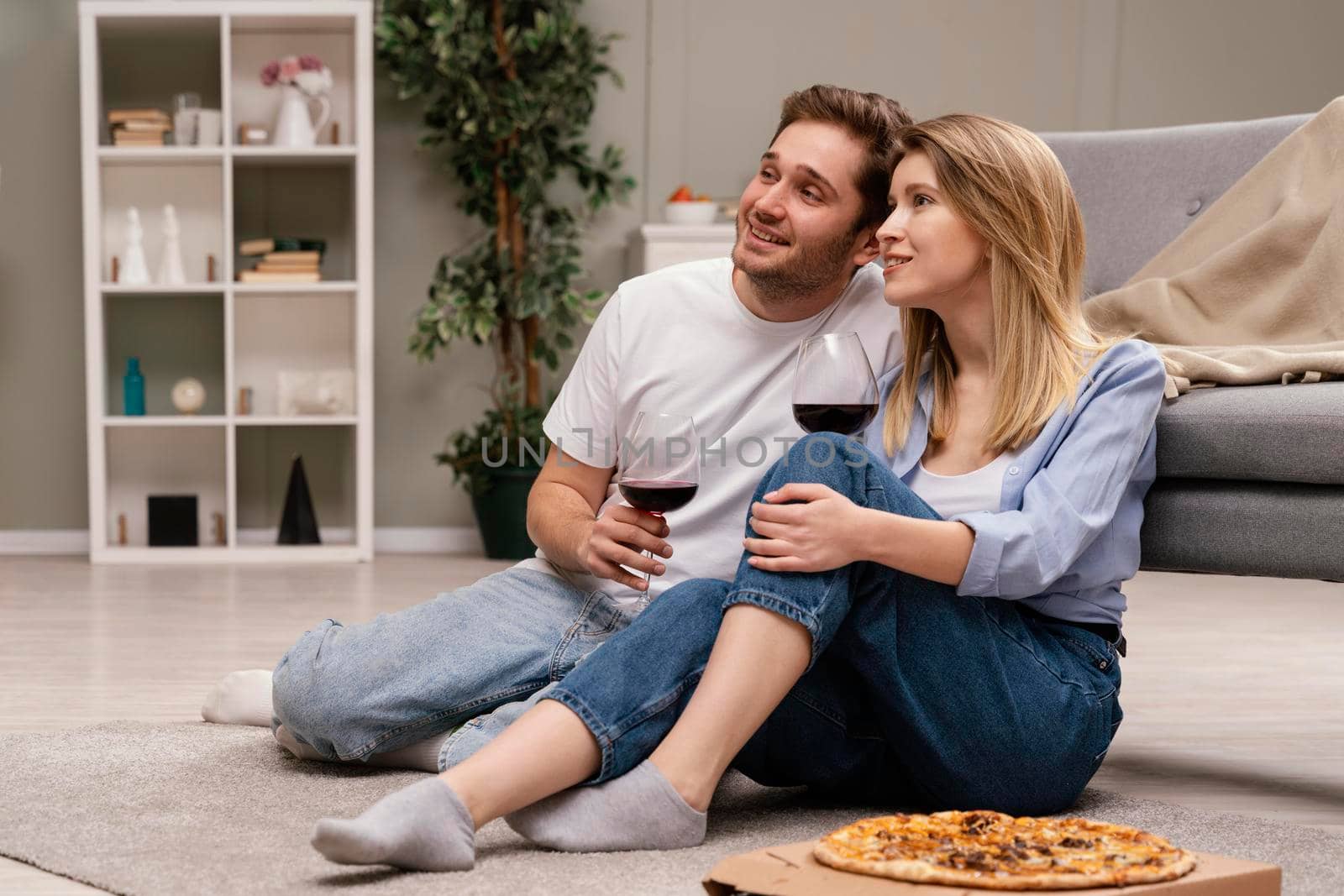 couple watching tv drinking wine