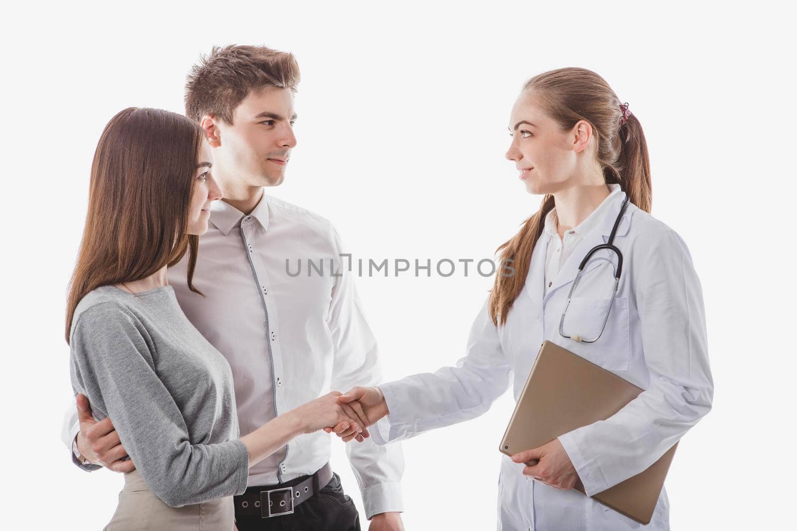 friendly medic handshaking with couple