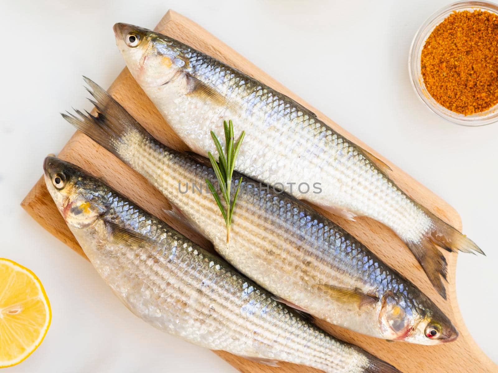 three fresh fish wooden bottom with condiments by Zahard