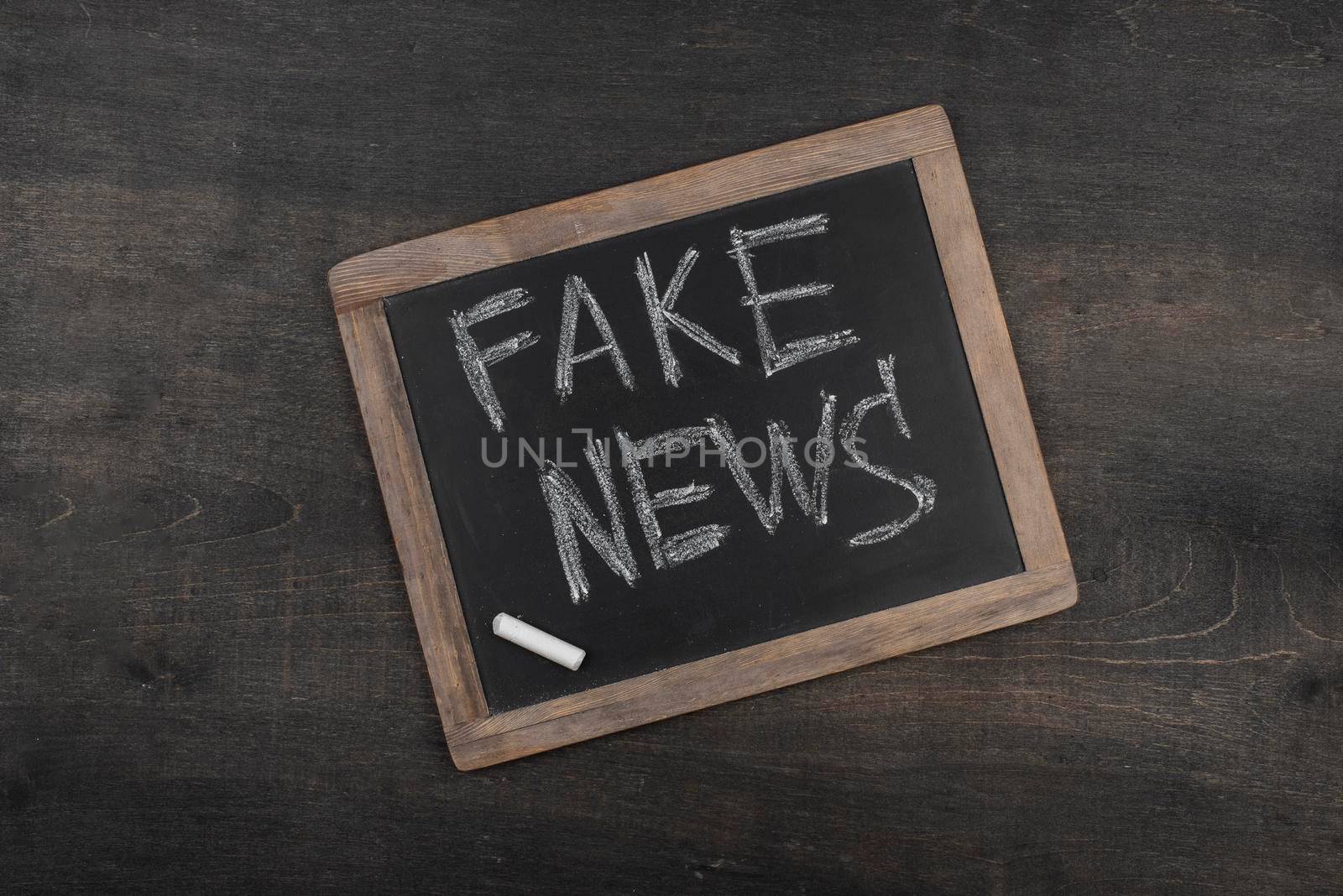 fake news concept with blackboard top view by Zahard