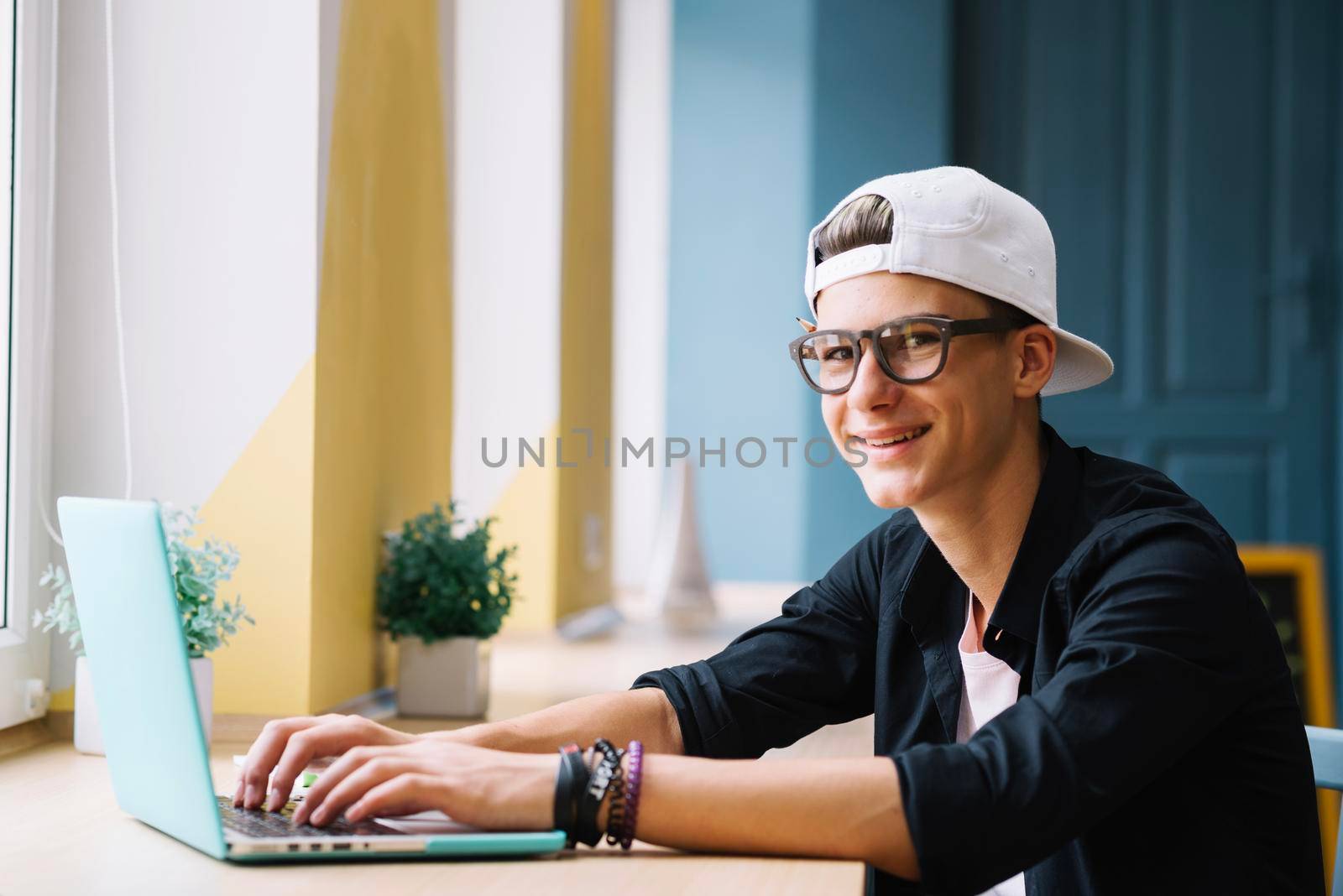 smiling youngster with gadget classroom by Zahard