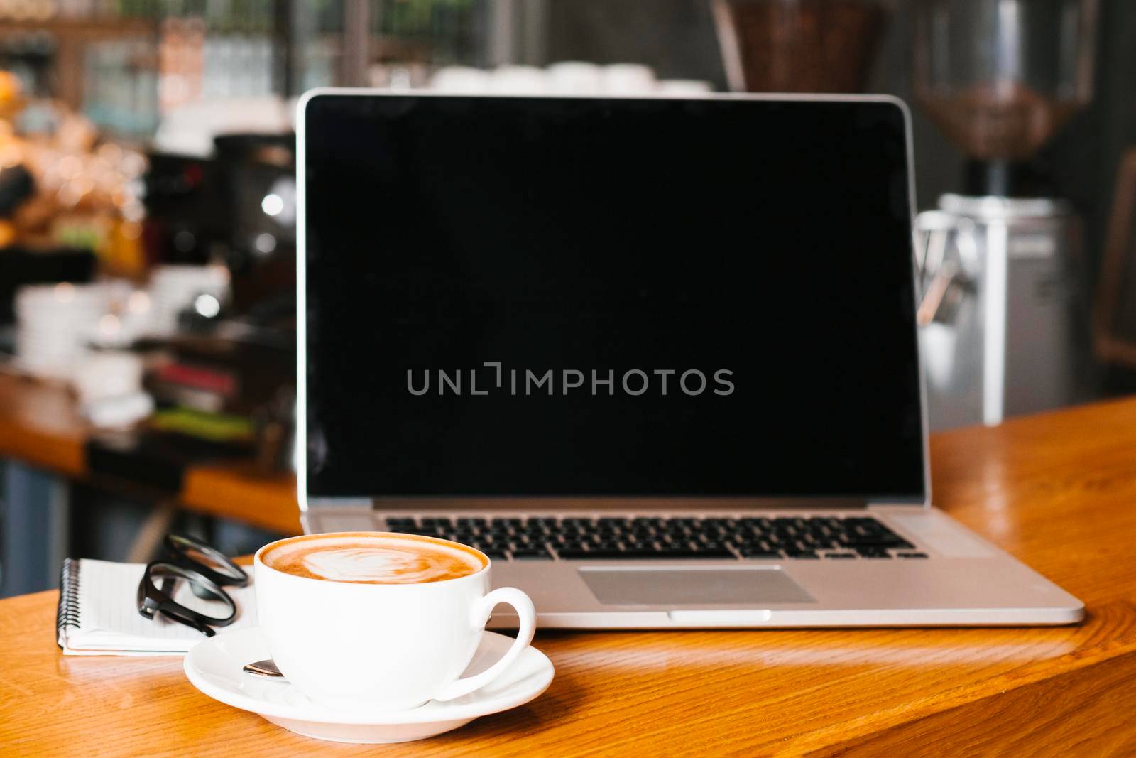 frontview laptop coffee wooden surface