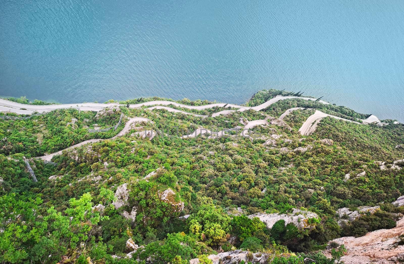 Aerial view of Ligurian mountainous roads bordered by the sea, travel reportage