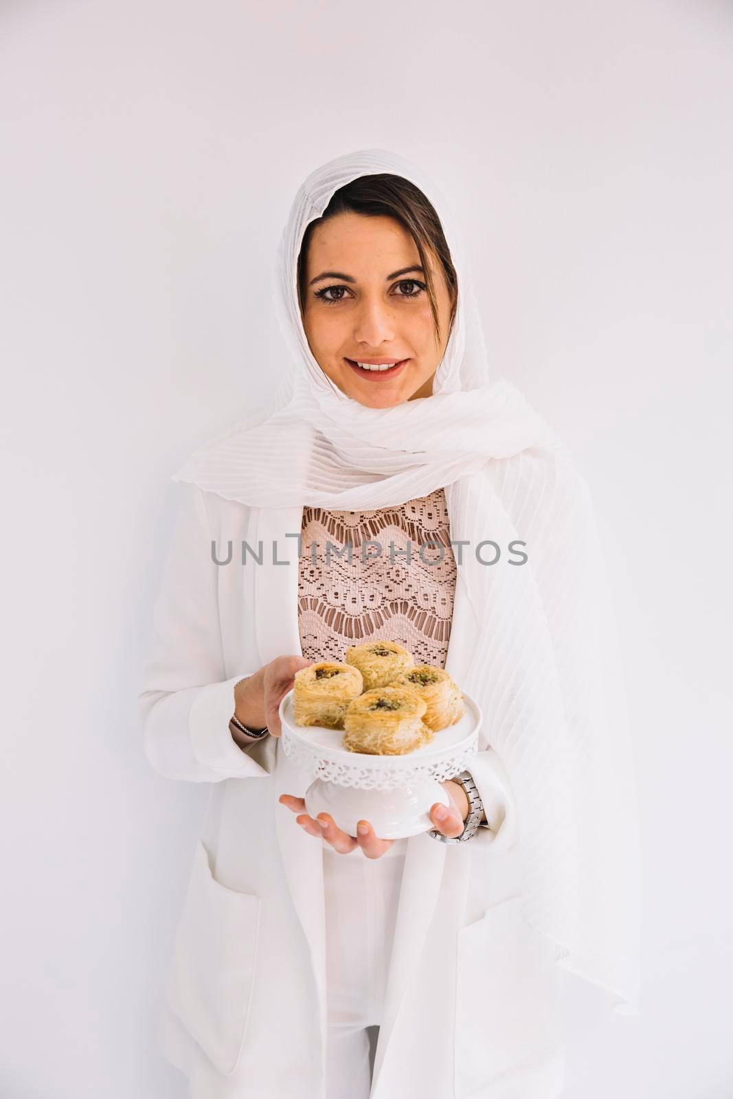 eid concept with woman holding arab pastry by Zahard
