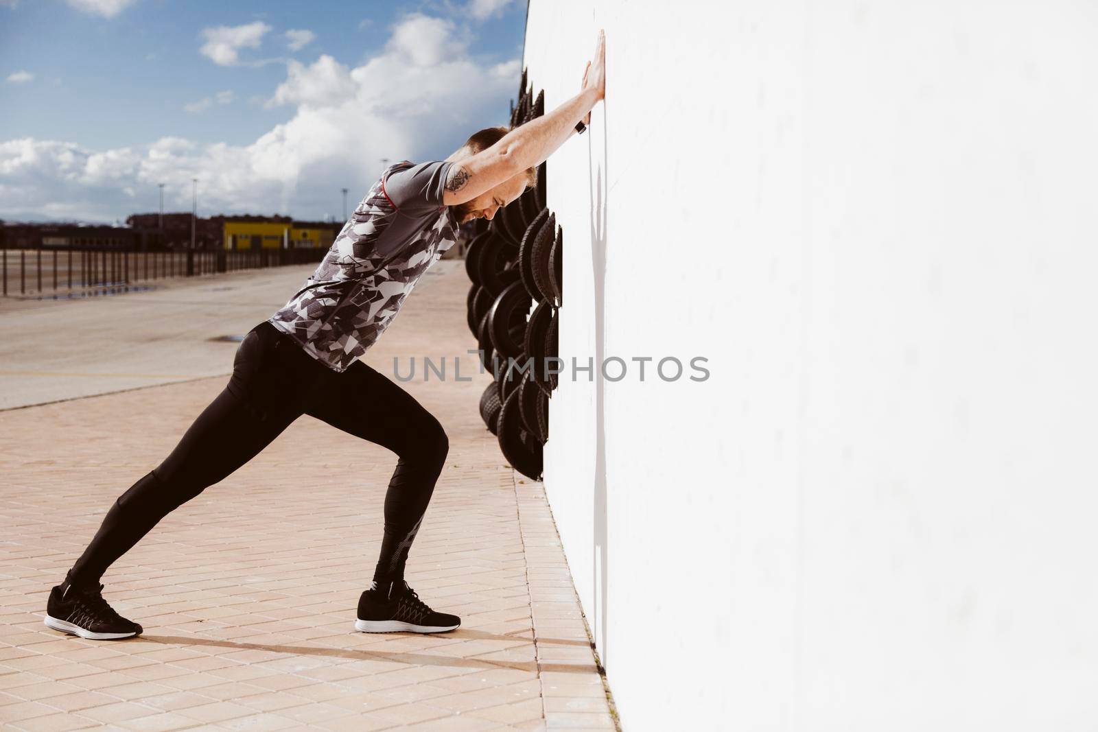 fitness man doing push ups against wall