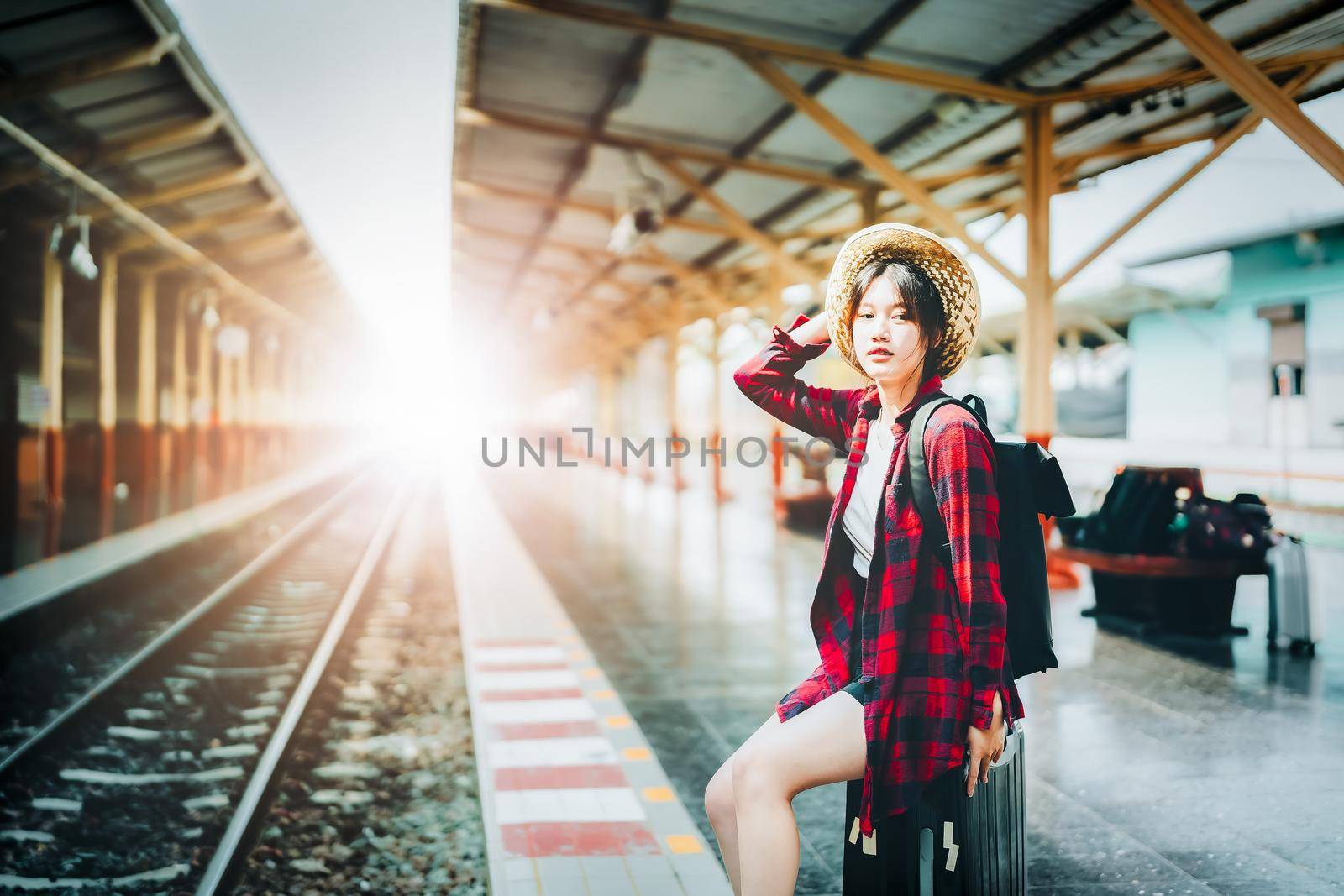 summer, relax, vacation, travel, portrait of cute Asian girl showing smile and waiting at the train station for a summer trip