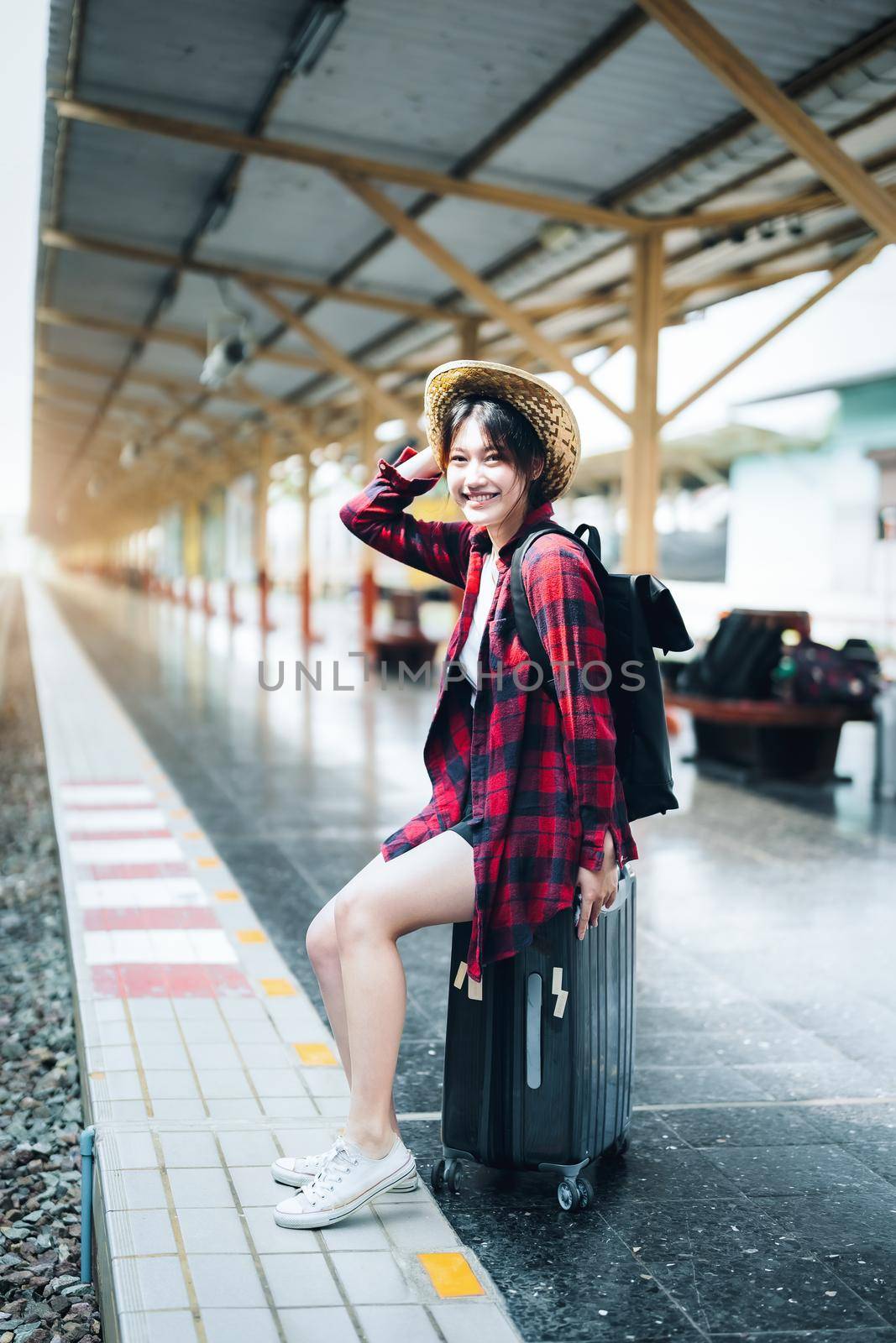 summer, relax, vacation, travel, portrait of cute Asian girl showing smile and waiting at the train station for a summer trip