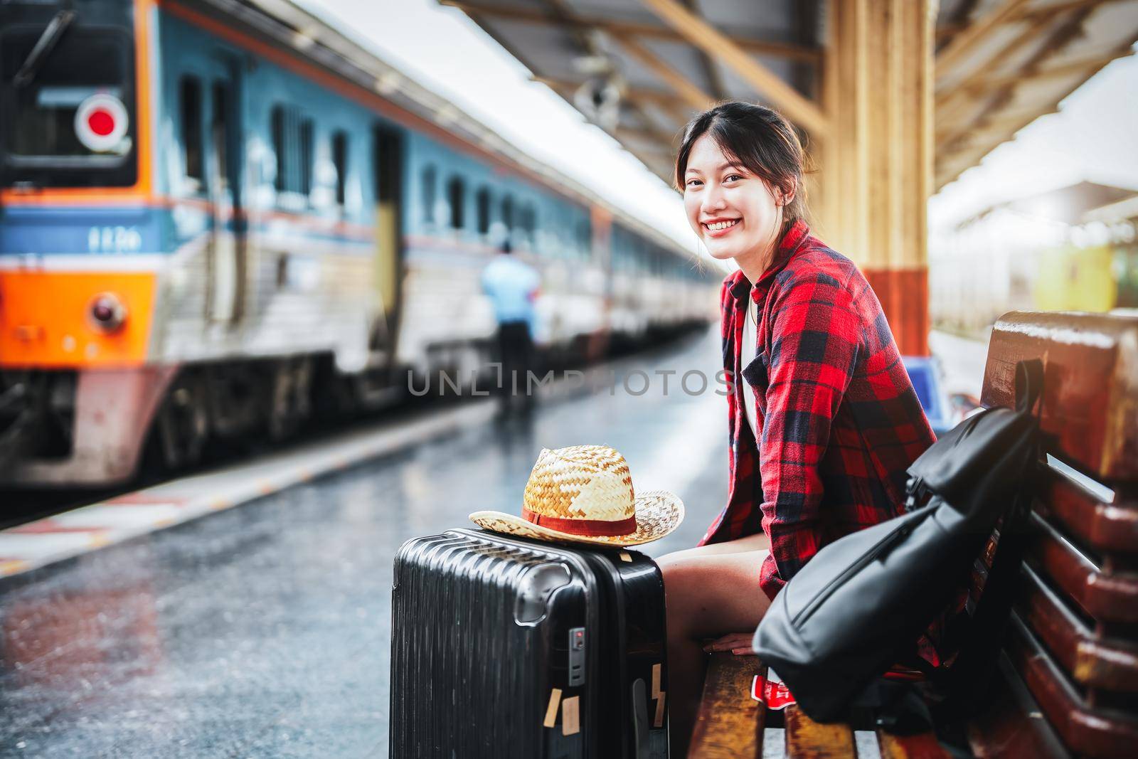 summer, relax, vacation, travel, portrait of cute Asian girl showing smile and waiting at the train station for a summer trip. by Manastrong