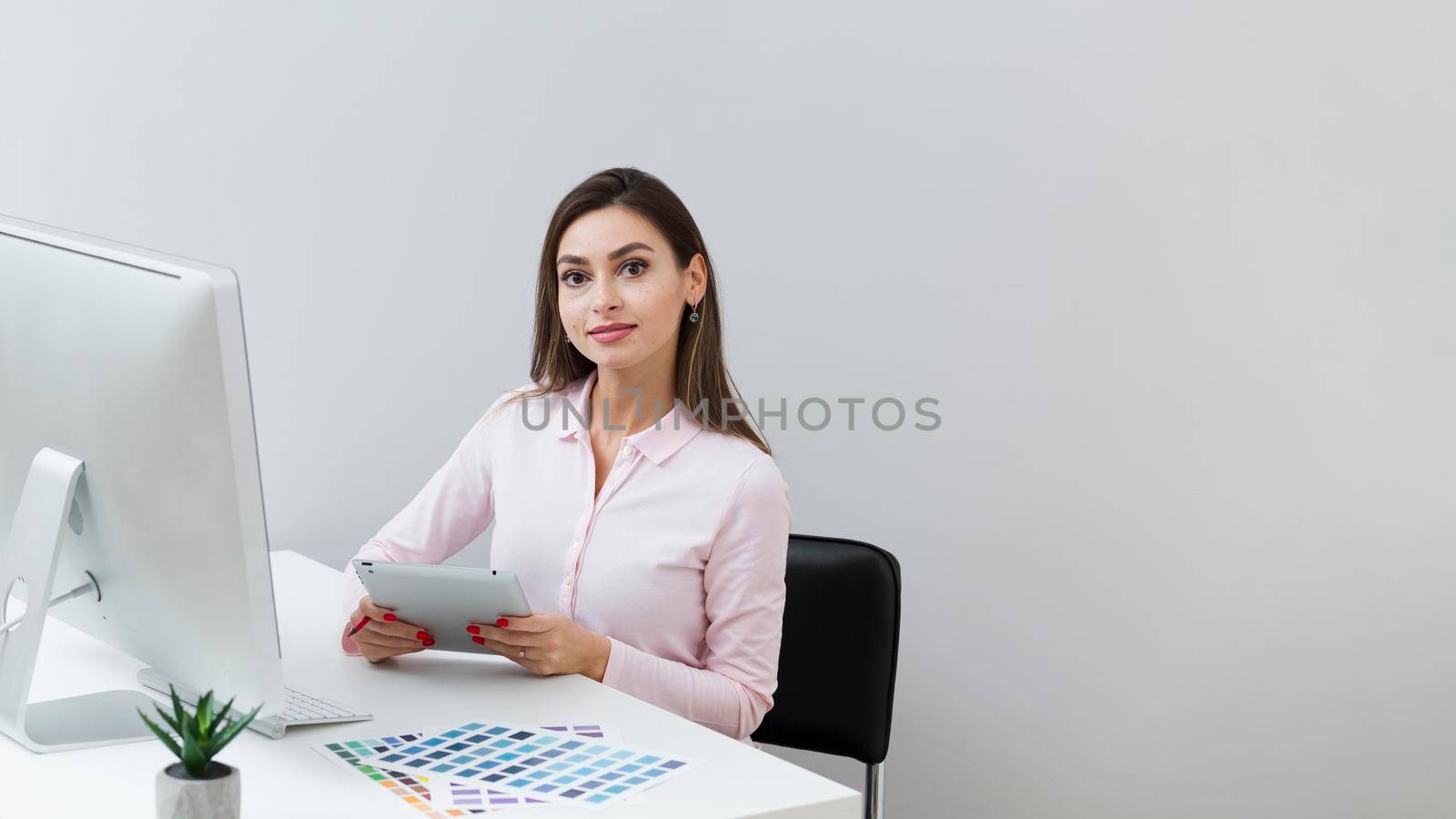 front view woman work holding tablet