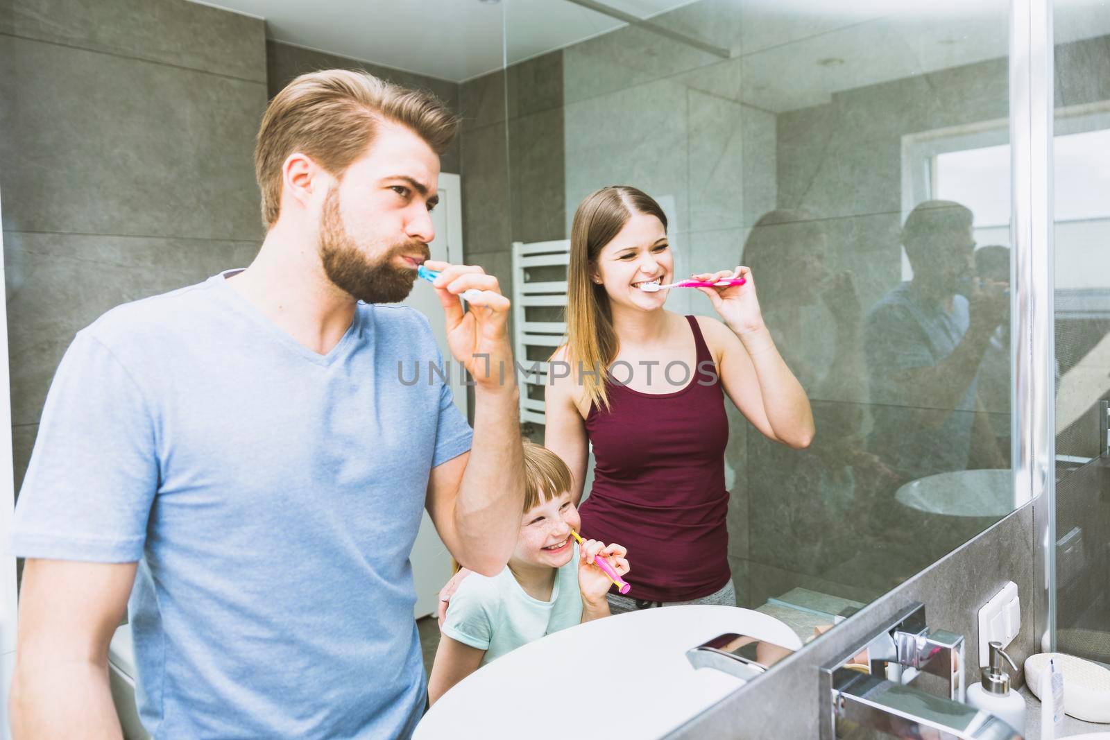 cheerful family brushing teeth by Zahard