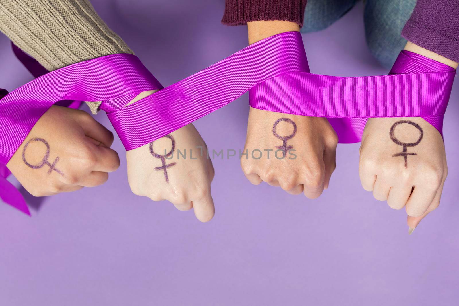 close up women hands with feminism symbol by Zahard