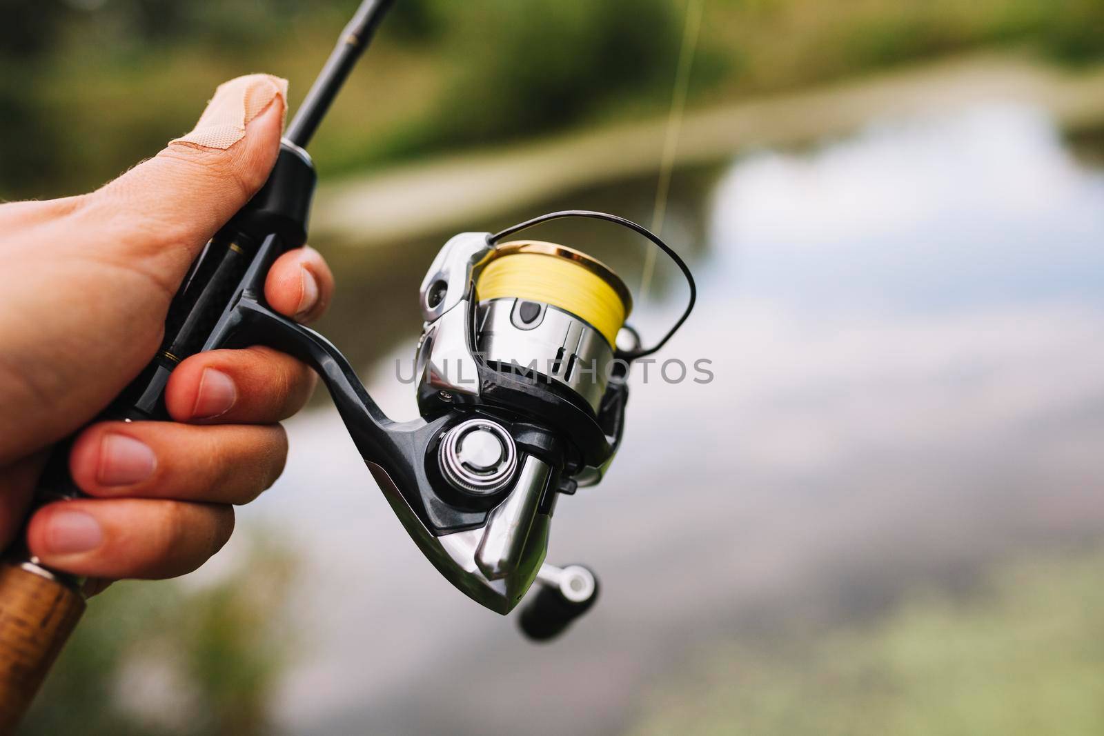 fisherman holding fishing rod blur background