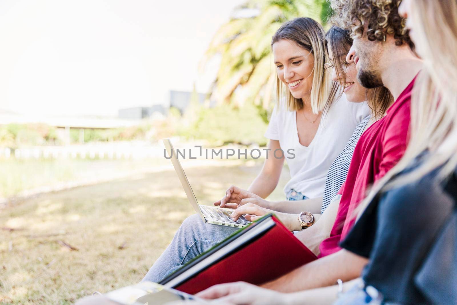 friends studying outside with laptop