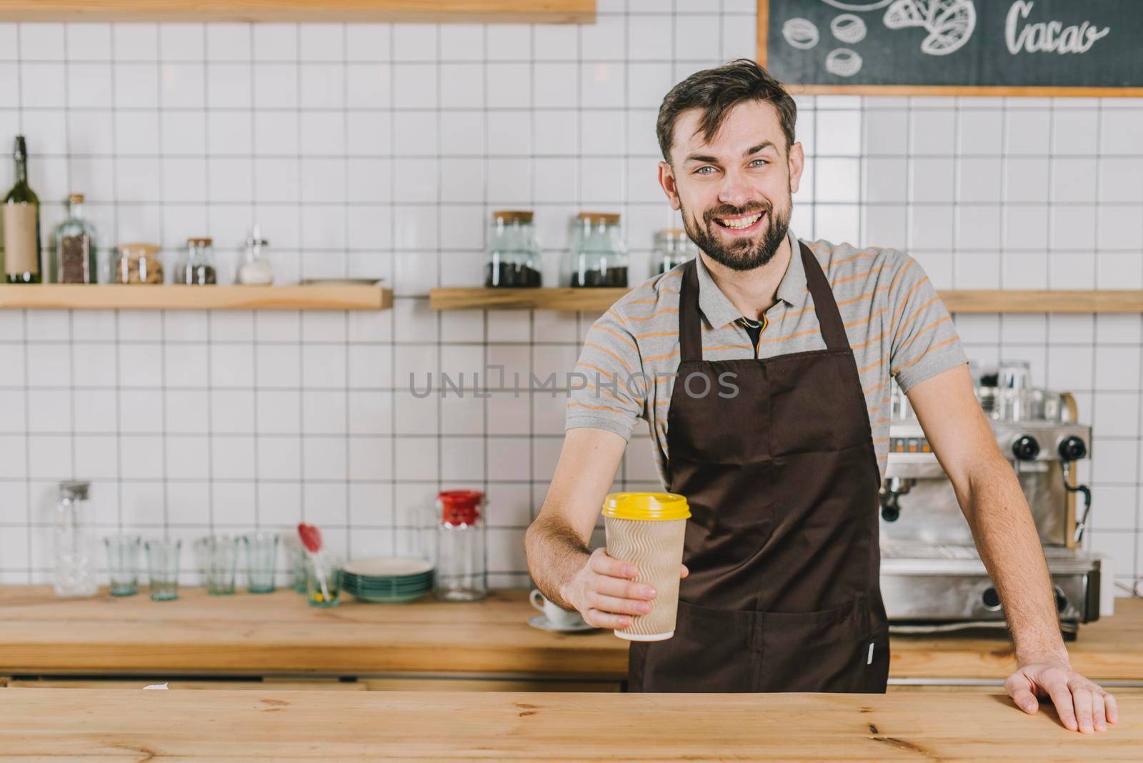 cheerful barista with cup