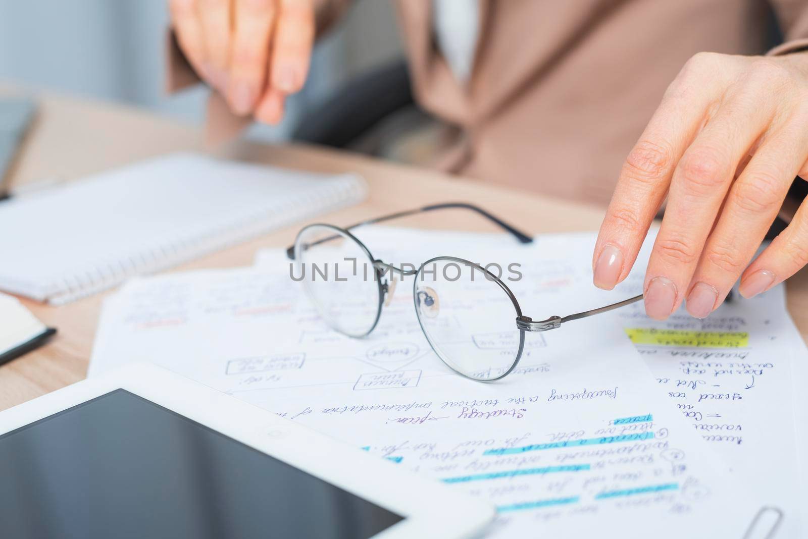 close up woman s hand holding eyeglasses document