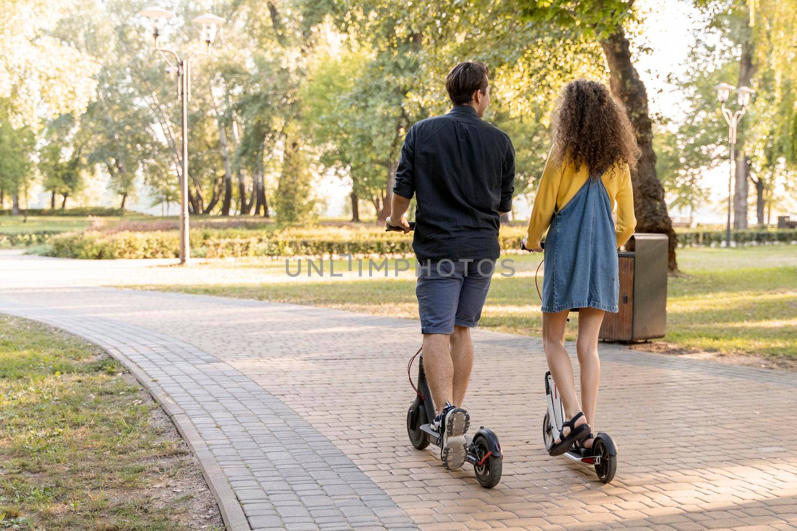 cute young couple riding scooter outdoors by Zahard