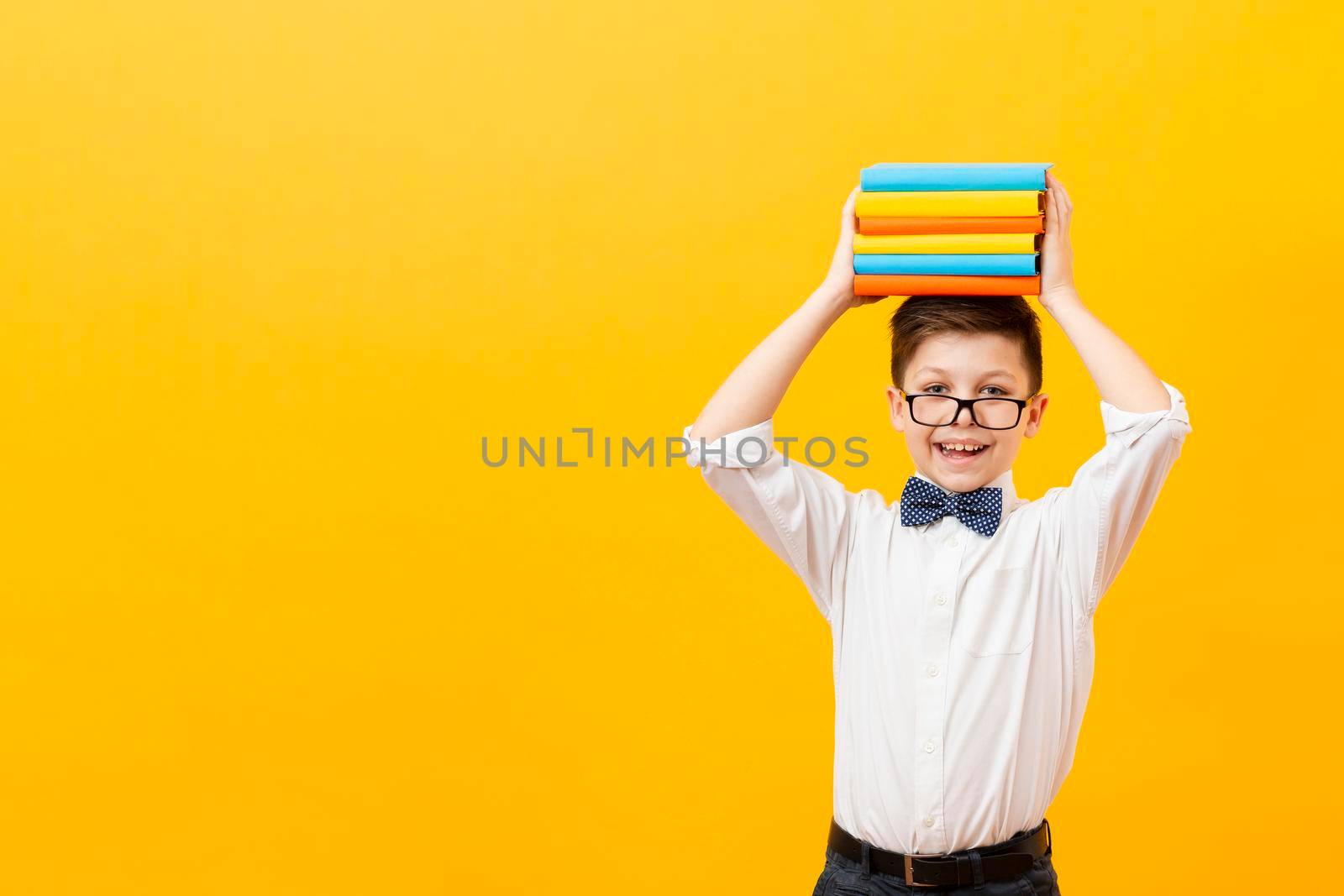copy space boy holding stack books