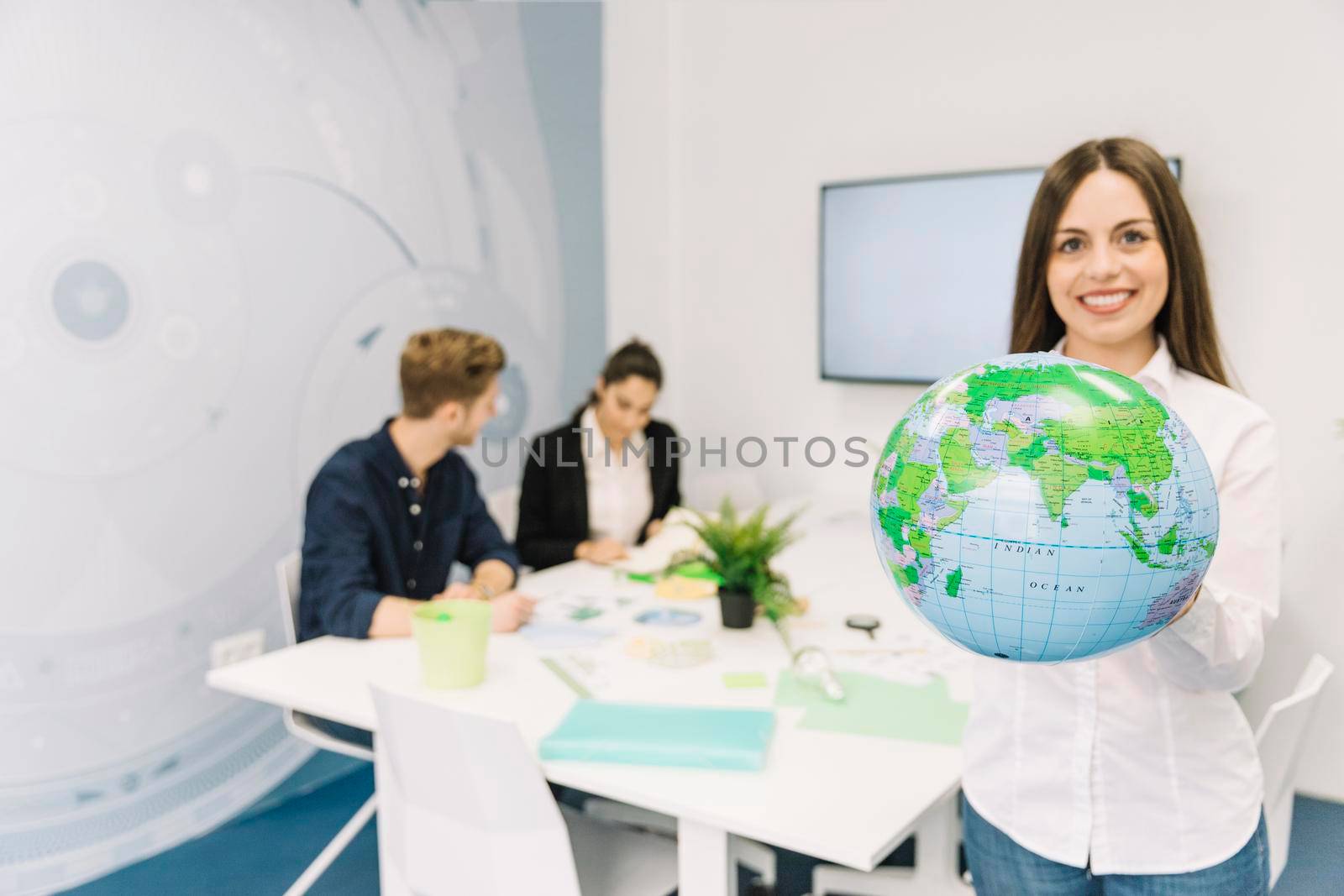 portrait happy businesswoman holding globe by Zahard