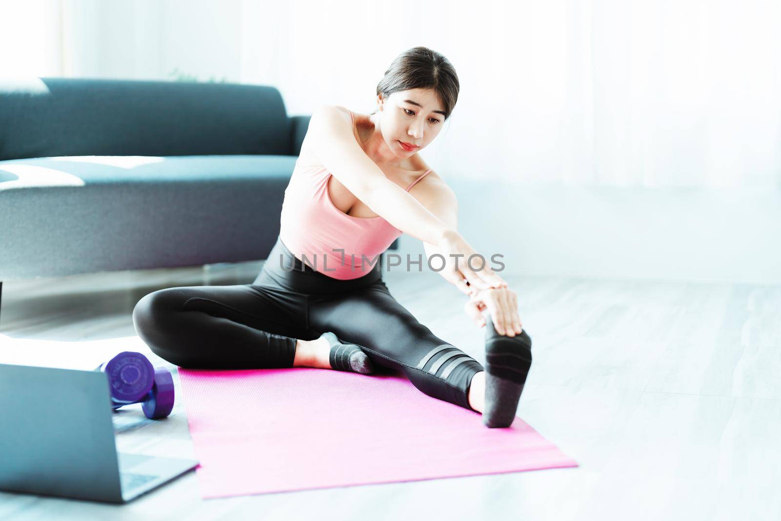 stress relief, muscle relaxation, breathing exercises, exercise, meditation, portrait of Young Asian woman relaxing her body from office work by practicing yoga by watching online tutorials. by Manastrong