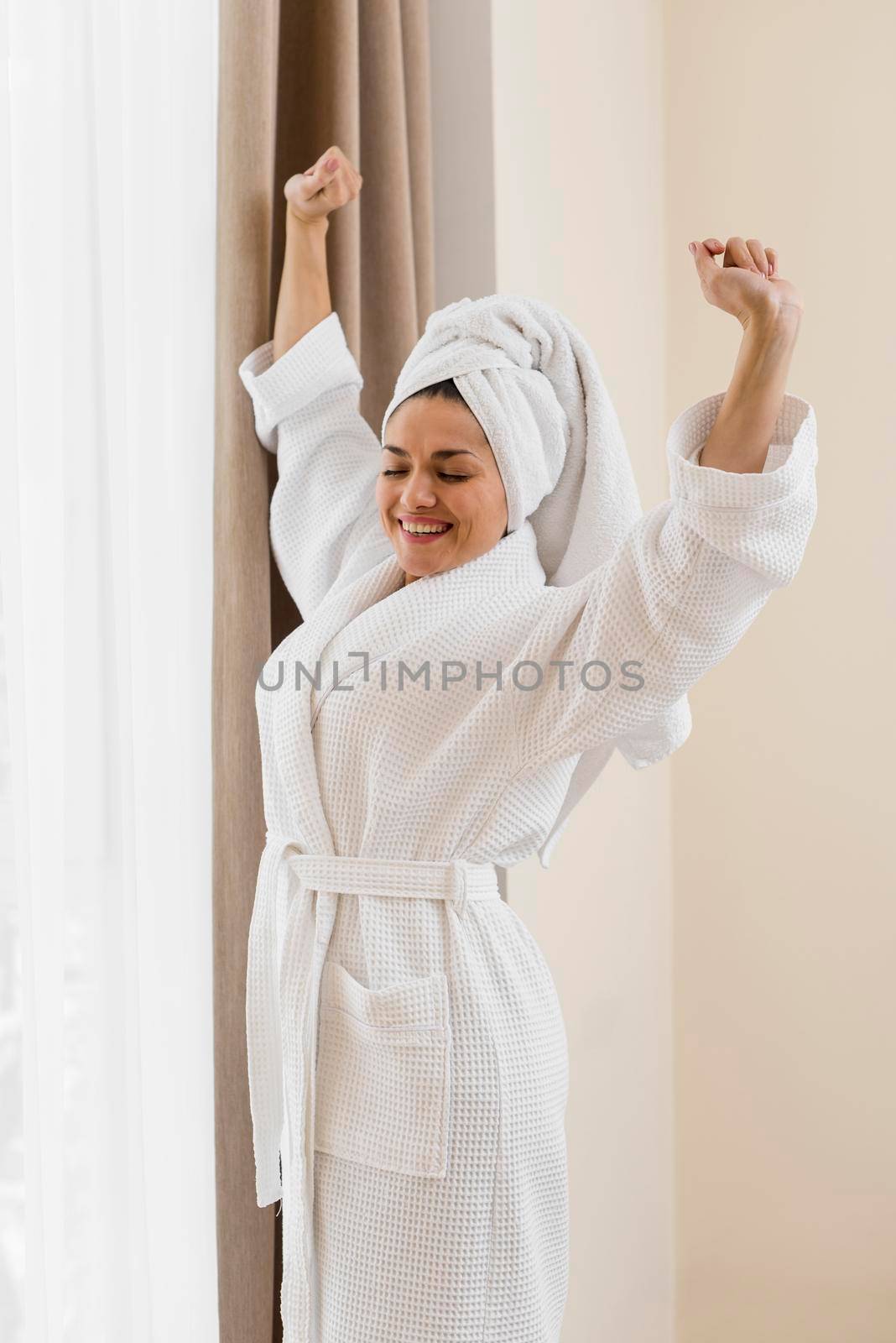 woman wearing bathrobe hotel room