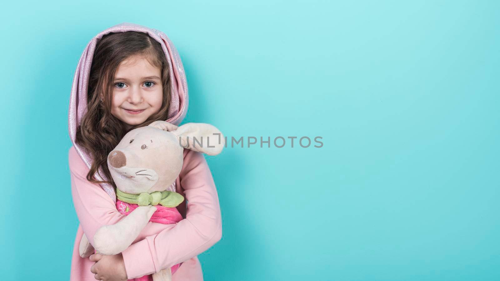 little girl standing with toy bunny